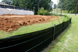 Freshly placed soil behind a silt fence.